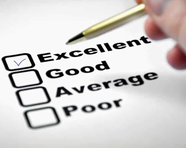 A survey form with four options: Excellent, Good, Average, and Poor. The box next to "Excellent" is checked with a blue pen. A hand holding a gold pen is visible near the selections, perhaps evaluating social housing quality. ©Mobysoft